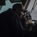 Sailor looks through a Sextant aboard USS Nimitz