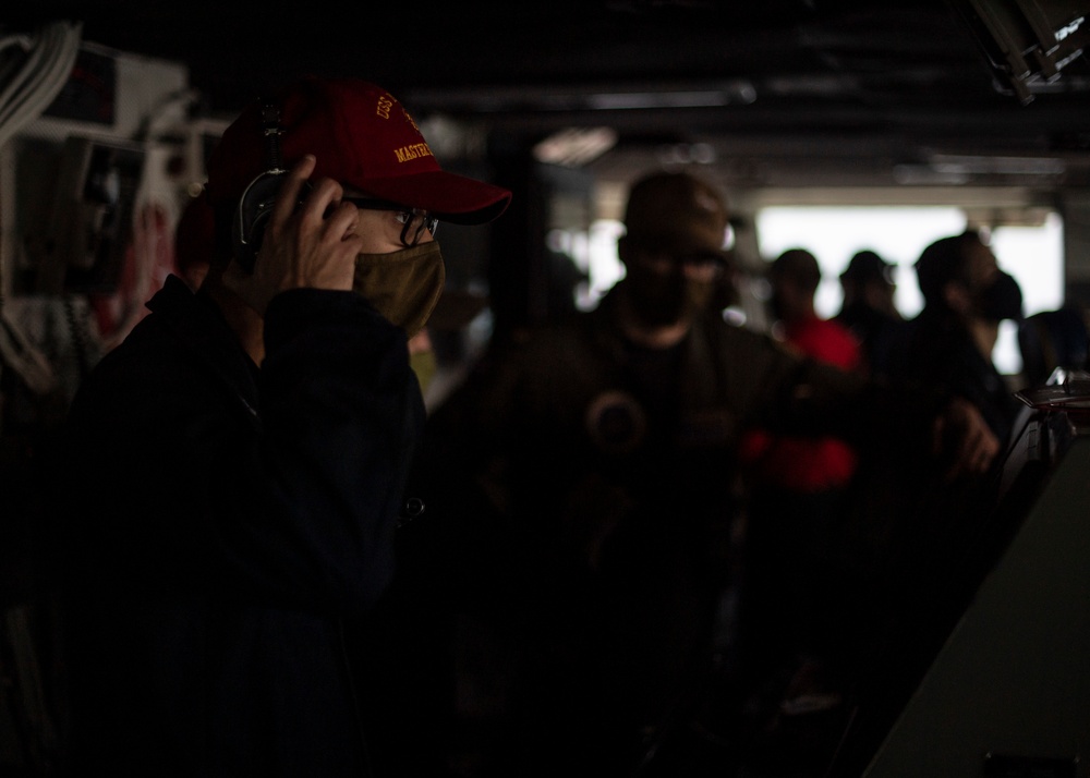 Master Helmsman stands watch aboard USS Nimitz