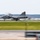 Sweden and U.S. Strengthen Air Capabilities During Swedish-led Bilateral Exercise A military jet fighter, marked with the number '821', is captured in motion on a runway, likely during takeoff or landing. The image uses a panning photography technique, creating motion blur in the background while keeping the aircraft relatively sharp. The aircraft appears to be a Saab JAS 39 Gripen based on its distinctive delta-canard wing configuration.