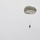 Sweden and U.S. Strengthen Air Capabilities During Swedish-led Bilateral Exercise A single parachutist is descending through an overcast, grey sky using a military-style round parachute. The canopy is olive/khaki green in color with visible panels and suspension lines connecting to the jumper below. The image is minimalist in composition with the subject positioned in the upper-right portion of the frame.