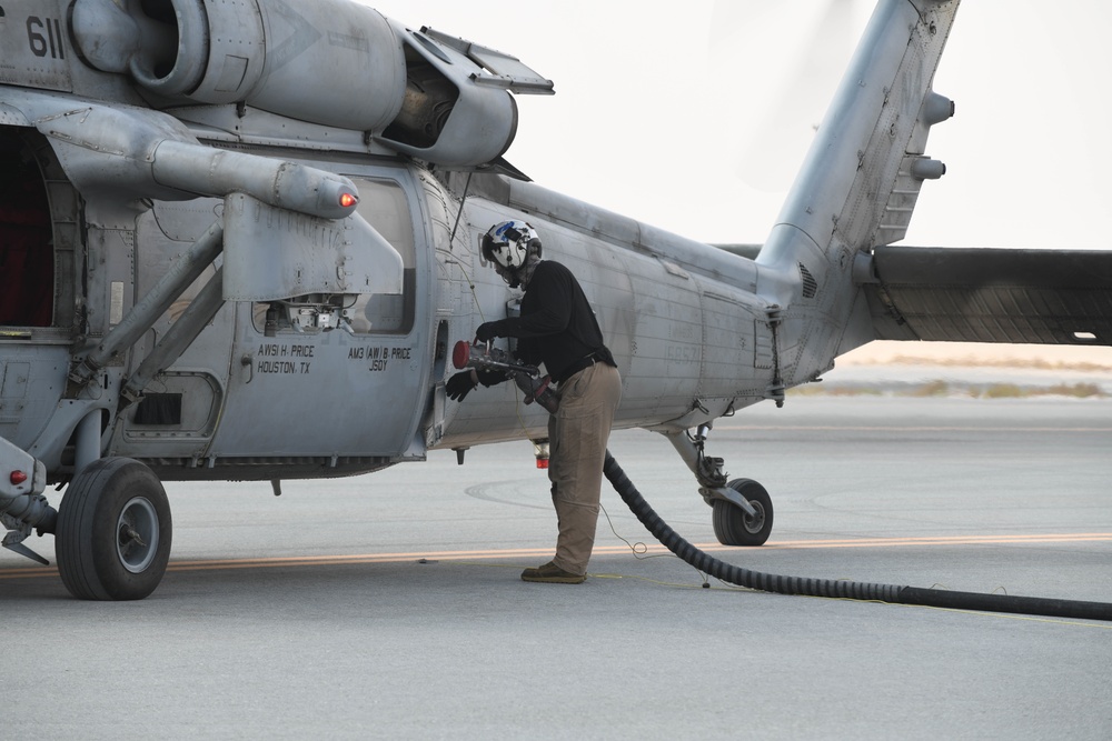 AUAB Airmen conduct hot-pit refueling on Navy MH-60S Seahawk helicopter