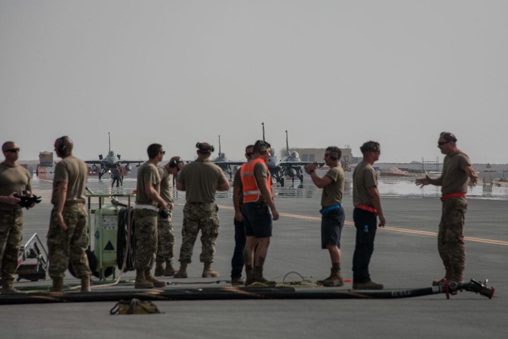 379th EMXG and 379th ELRS perform hot-pit refueling on F-16 Fighting Falcons