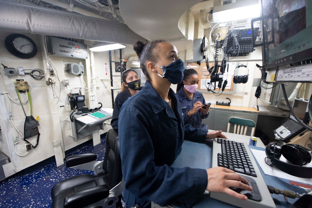 USS Ralph Johnson Sailors Check Engineering Log