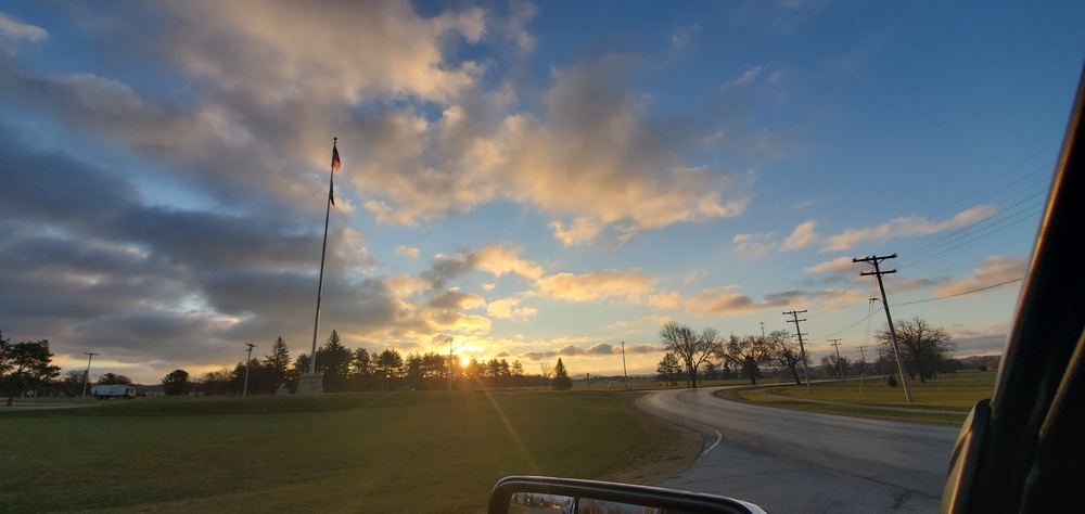 American flag, sunrise, and Veterans Day at Fort McCoy