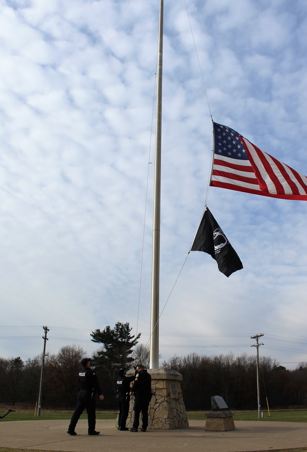 Fort McCoy Police Department officers complete flag raising event