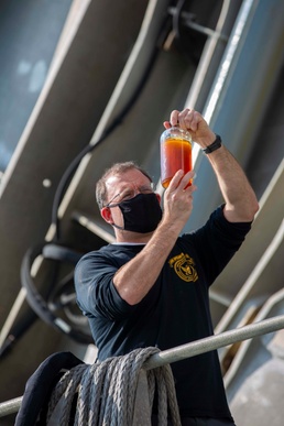 Chief Engineer onboard USNS Yuma checks fuel