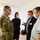 Guard medical team supports Czech partners A group of four individuals are engaged in a discussion in what appears to be an indoor facility. One person is wearing a U.S. Army military uniform with an American flag patch, while the others appear to be civilian professionals, including one in medical/healthcare attire. All individuals are wearing face masks, suggesting this was taken during the COVID-19 pandemic period.
