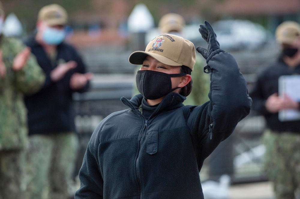 Aviation Structural Mechanic Seaman Apprentice Martinez dons her USS Constitution command ball cap for the first time after completing his basic historian qualification