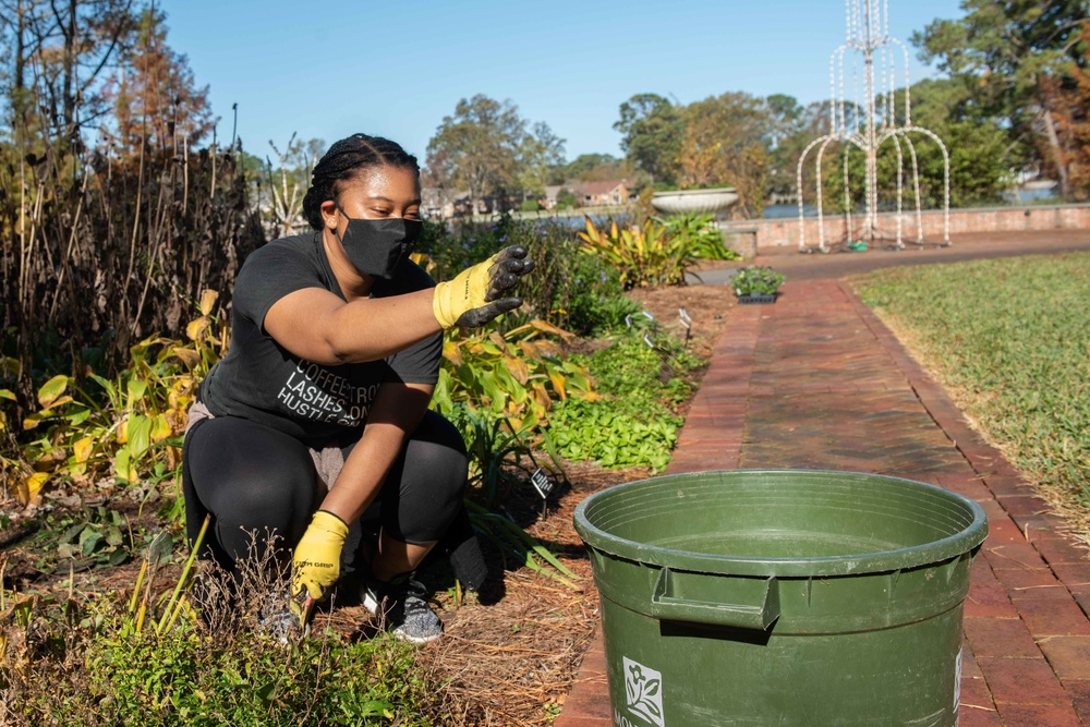 Sailor pulls weeds during comrel