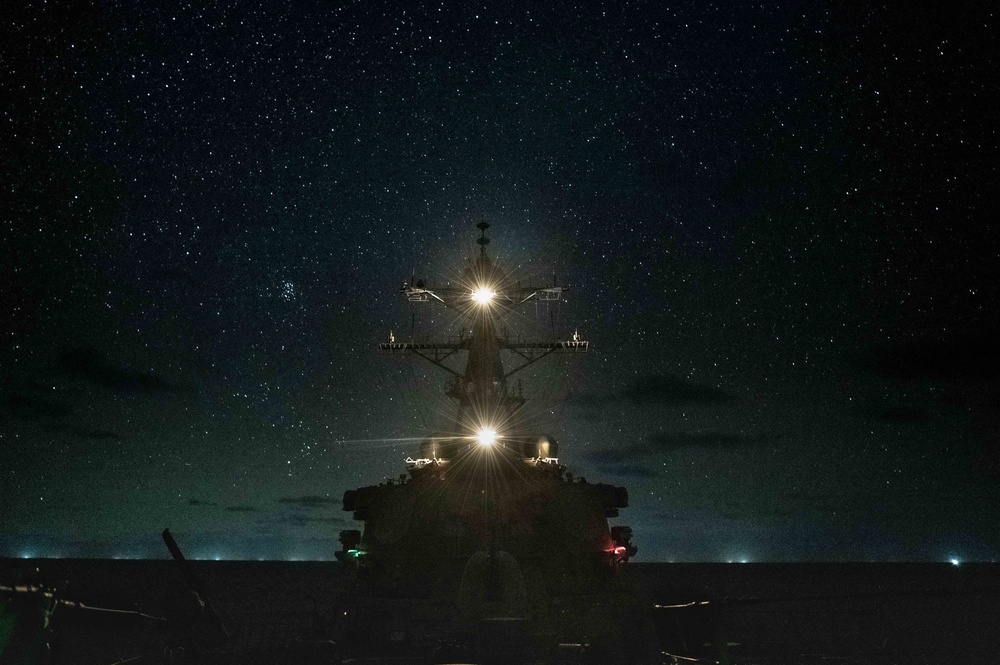 USS Barry Operates Under Night Stars