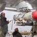 Sailors load an AGM-84D Harpoon missile onto a P-8A Poseidon.