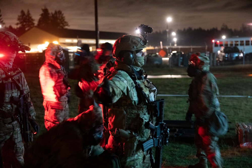 A Green Beret from 1st Special Forces Group (Airborne) is decontaminated by a soldier