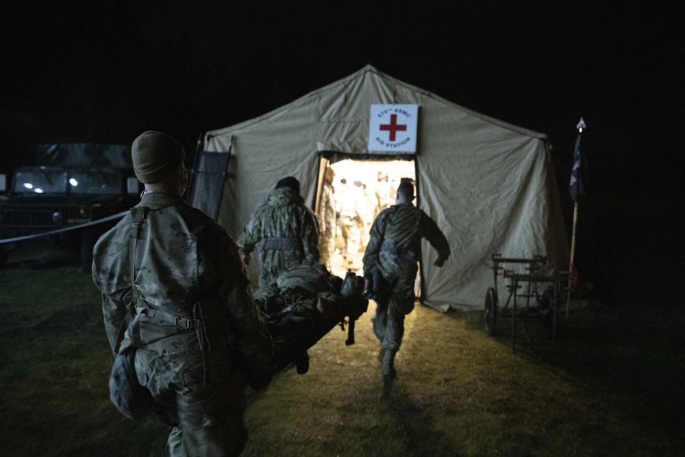 Soldiers with 62nd Medical Brigade provide simulated care to a casualty