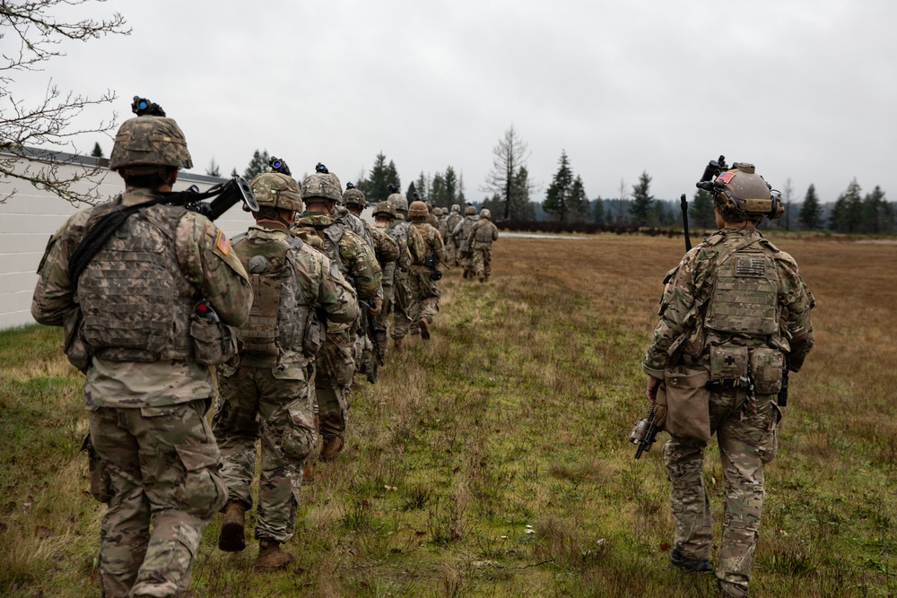 Soldiers follow Green Beret during training exercise