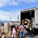 Honduran Volunteers Load Donated Medical Supplies and Equipment