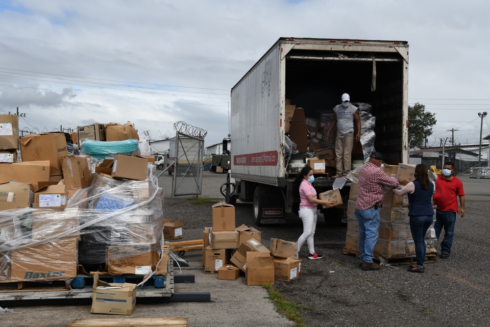 Honduran Volunteers Load Donated Medical Supplies and Equipment