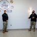 Master-at-Arms 1st Class Damon Harris reenlists in the United States Navy