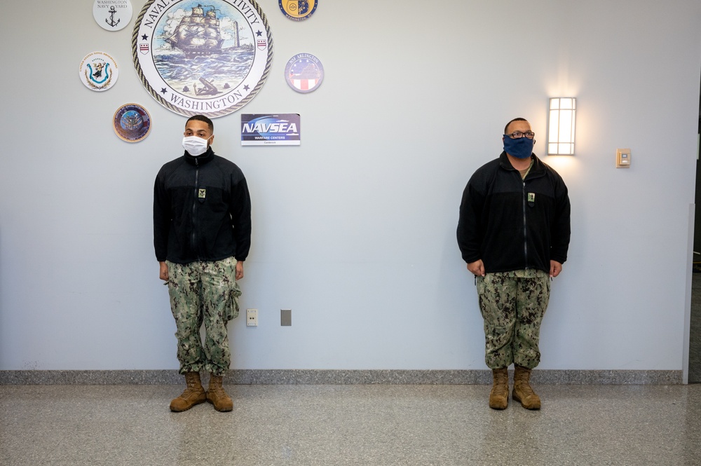 Master-at-Arms 1st Class Damon Harris reenlists in the United States Navy