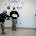 Master-at-Arms 1st Class Damon Harris reenlists in the United States Navy