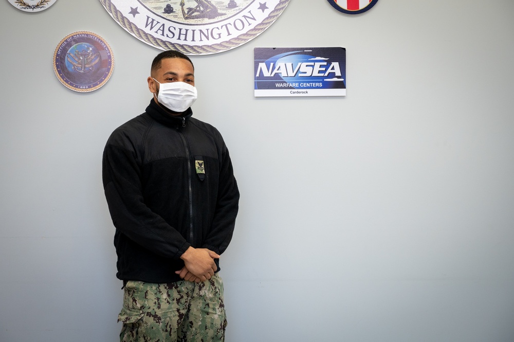 Master-at-Arms 1st Class Damon Harris reenlists in the United States Navy