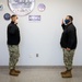 Master-at-Arms 1st Class Damon Harris reenlists in the United States Navy