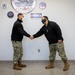 Master-at-Arms 1st Class Damon Harris reenlists in the United States Navy