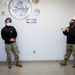 Master-at-Arms 1st Class Damon Harris reenlists in the United States Navy