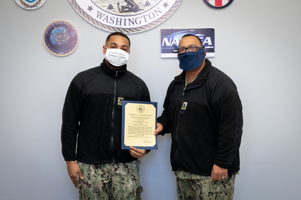 Master-at-Arms 1st Class Damon Harris reenlists in the United States Navy