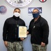 Master-at-Arms 1st Class Damon Harris reenlists in the United States Navy