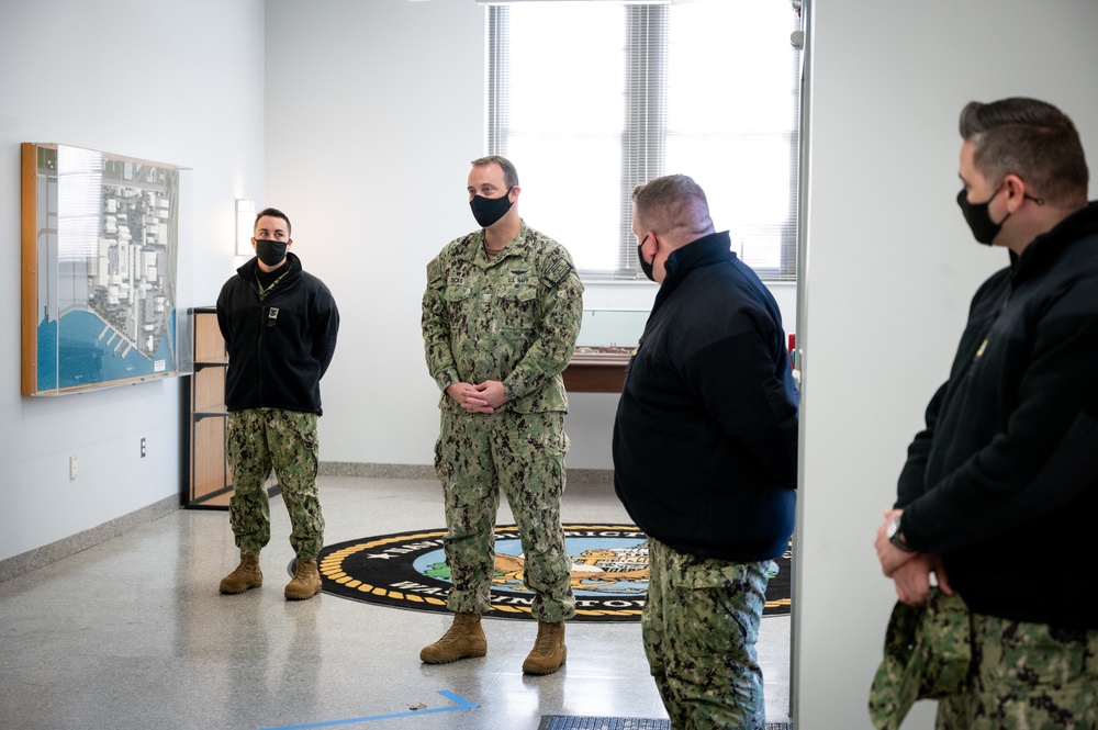 Master-at-Arms 1st Class Damon Harris reenlists in the United States Navy