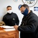 Master-at-Arms 1st Class Damon Harris reenlists in the United States Navy