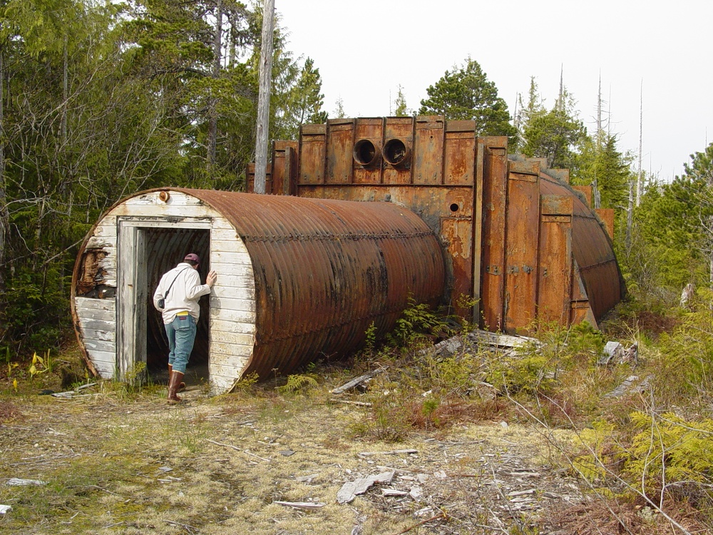 Community member peers into an abandoned former military structure