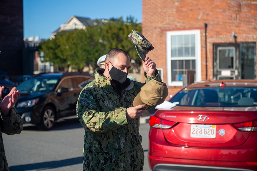 nformation Systems Technician 1st Class Ryan Arsenault recieves ball cap for getting his Basic Historian qualifiication aboard the USS Constitution.