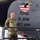 A U.S. Air Force service member in OCP (Operational Camouflage Pattern) uniform stands on a maintenance platform beside a KC-135R Stratotanker aircraft inside a hangar. The aircraft bears serial number 60-0342 and markings for the 6th Air Refueling Wing (6 ARW) and 927th Air Refueling Wing (927 ARW). A nose art emblem reading 'Let's Roll' featuring a bald eagle over an American flag is prominently displayed on the fuselage.