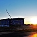 Sun sets next to new barracks at Fort McCoy