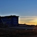 Sun sets next to new barracks at Fort McCoy