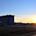 Sun sets next to new barracks at Fort McCoy