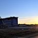 Sun sets next to new barracks at Fort McCoy