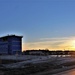 Sun sets next to new barracks at Fort McCoy