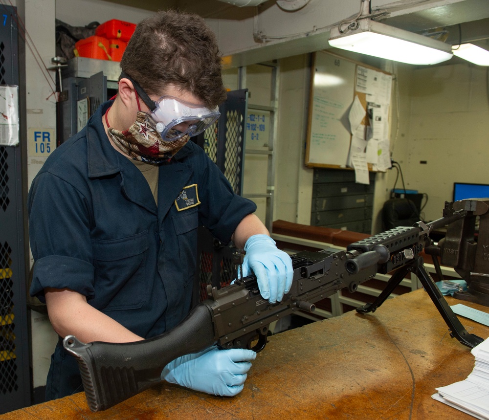 A Sailor Disassembles a Firearm