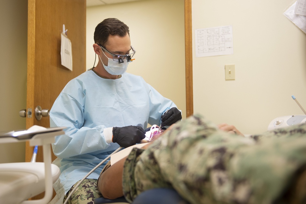 Navy Dental Officer Performs Examinations on Seabee Deployment