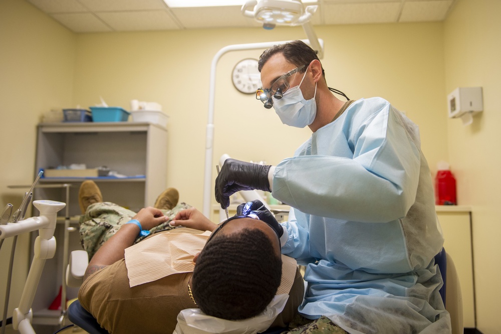 Navy Dental Officer Performs Examinations on Seabee Deployment