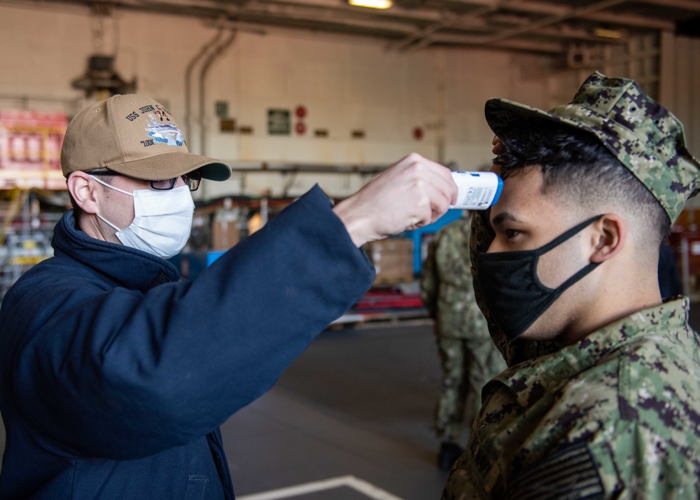 U.S. Sailor medically screens another Sailor