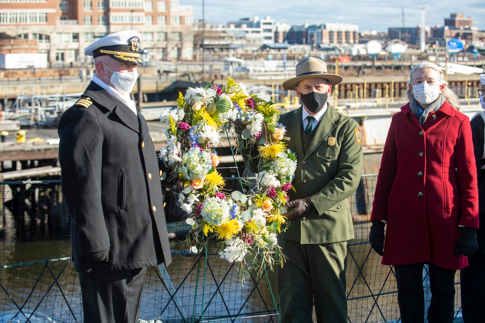 USS Constitution Commanding Officer John Benda and National Park Service of Boston Superintendent Michael Creasey pose for a photo in front of a reef during a commemoration of Pearl Harbor for a Facebook live event onboard USS Cassin Young