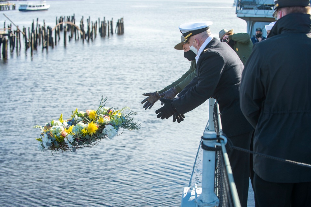 USS Constitution Commanding Officer John Benda and National Park Service of Boston Superintendent Michael Creasey toss a reef during a commemoration of Pearl Harbor for a Facebook live event onboard USS Cassin Young