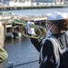 Seaman Jaida Williams, assigned to USS Constitution, plays Taps during a commemoration of Pearl Harbor for a Facebook live event onboard USS Cassin Young