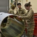 Maintainers construct external fuel tanks