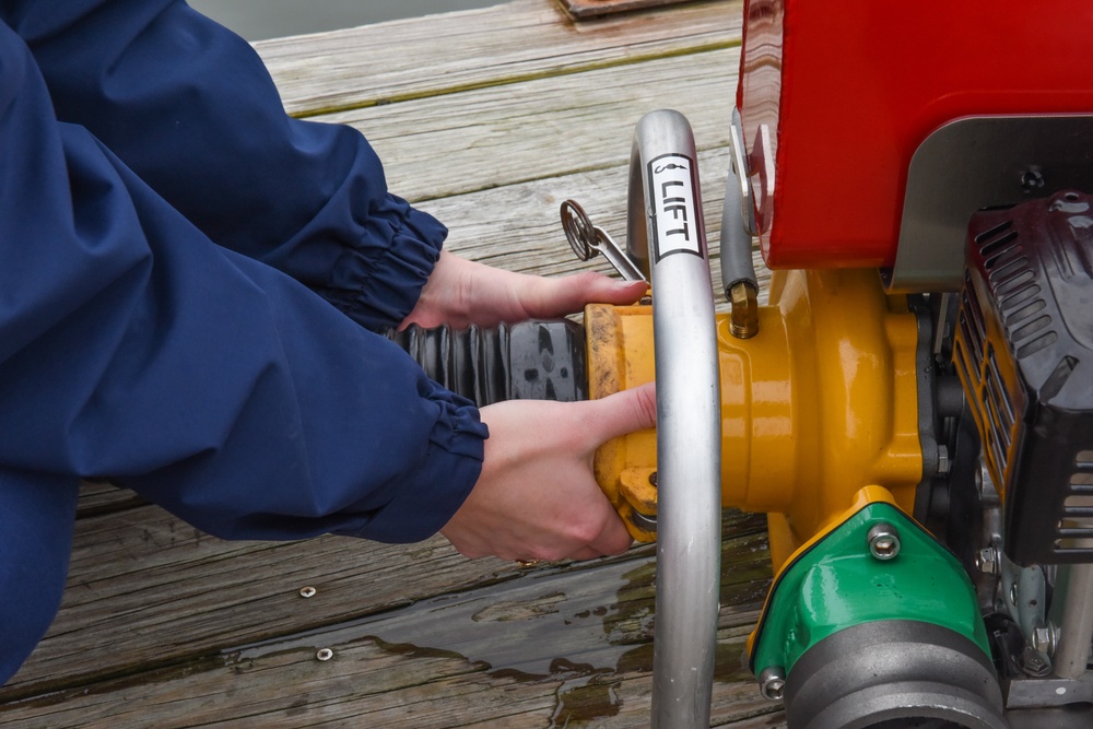 Coast Guardsman conducts monthly dewatering pump test