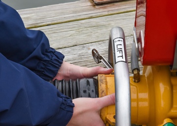 Coast Guardsman conducts monthly dewatering pump test
