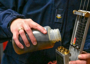 Coast Guardsman conducts daily vessel oil test
